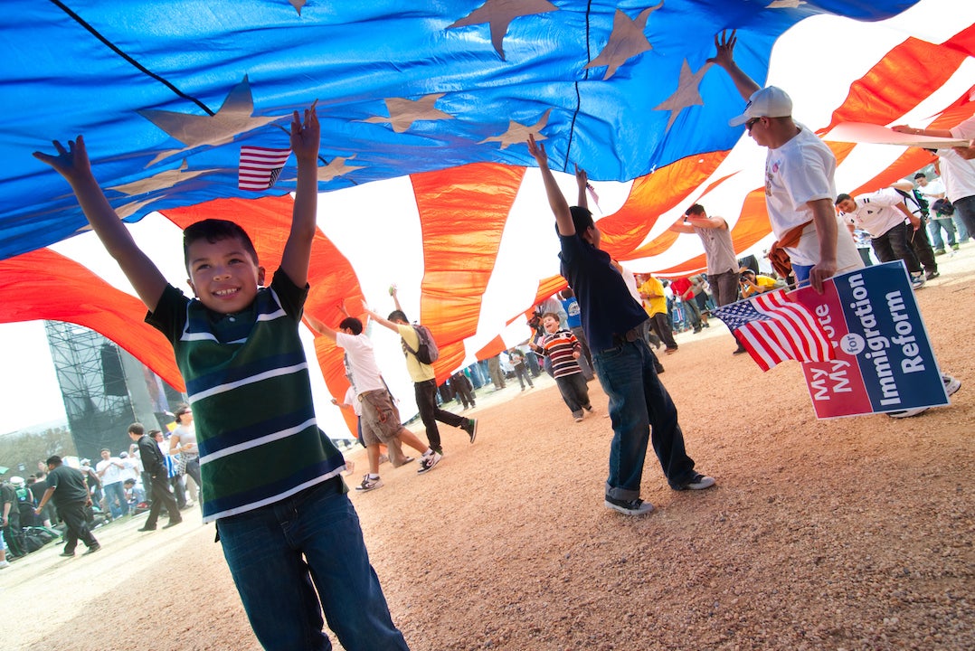 Massive American flag being held up at immigration reform demonstration