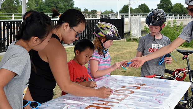 Kids of all ages signing poster