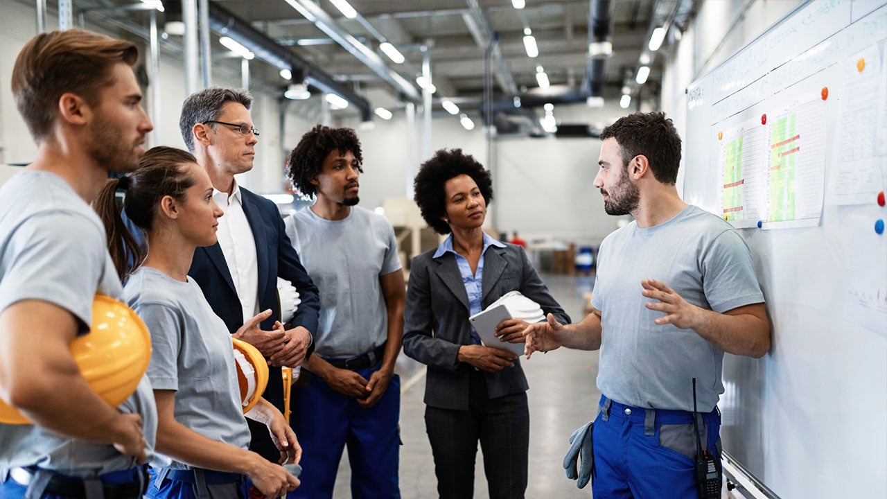 coworkers reviewing information on white board