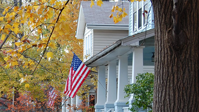 Rural house with American flag on porch