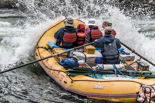 People in boat white water rafting