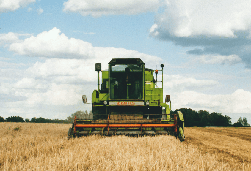 Farm machinery harvesting crops