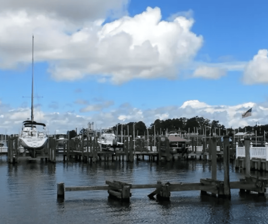 Boats docked on side of lake on clear day