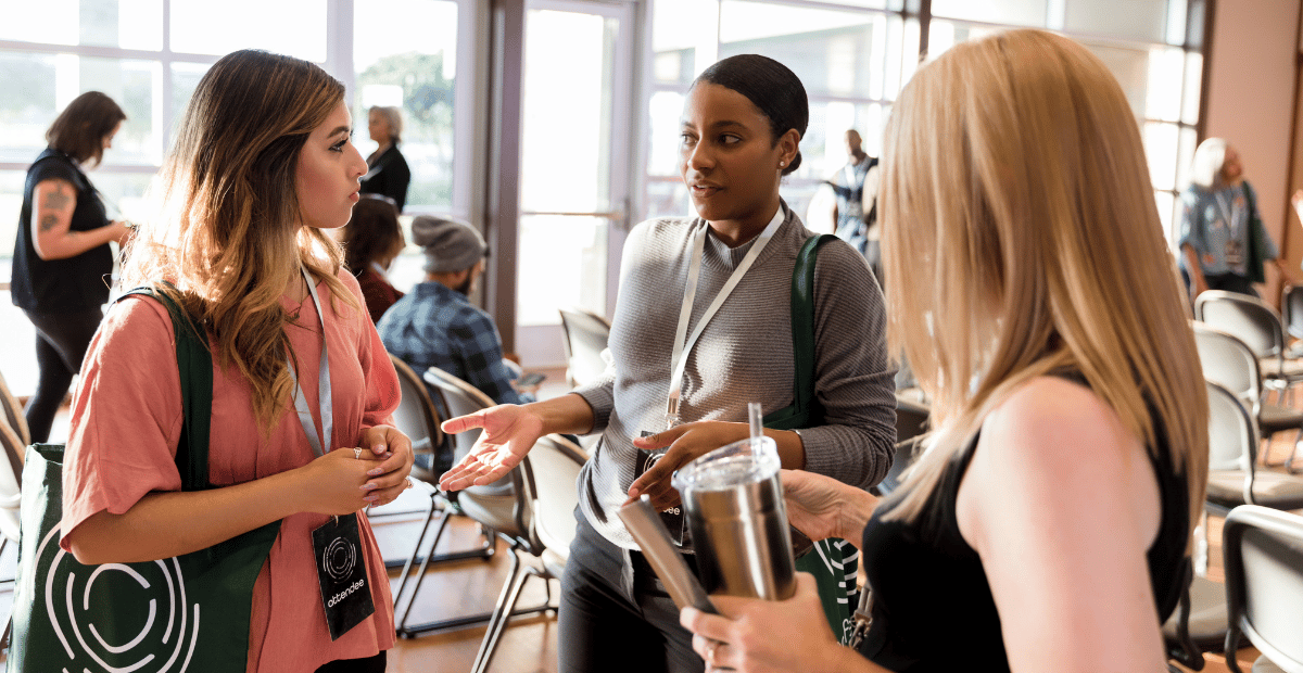 Three women talk during a conference