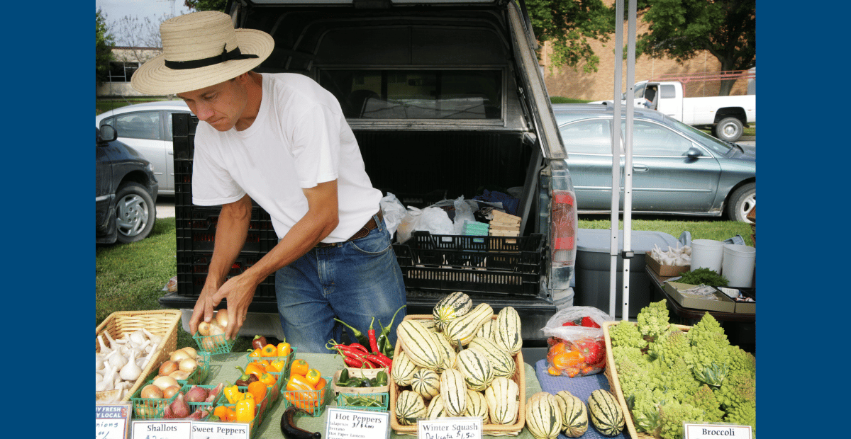 Image of man selling produce at farmer's market