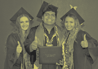 Graduates smiling with diploma