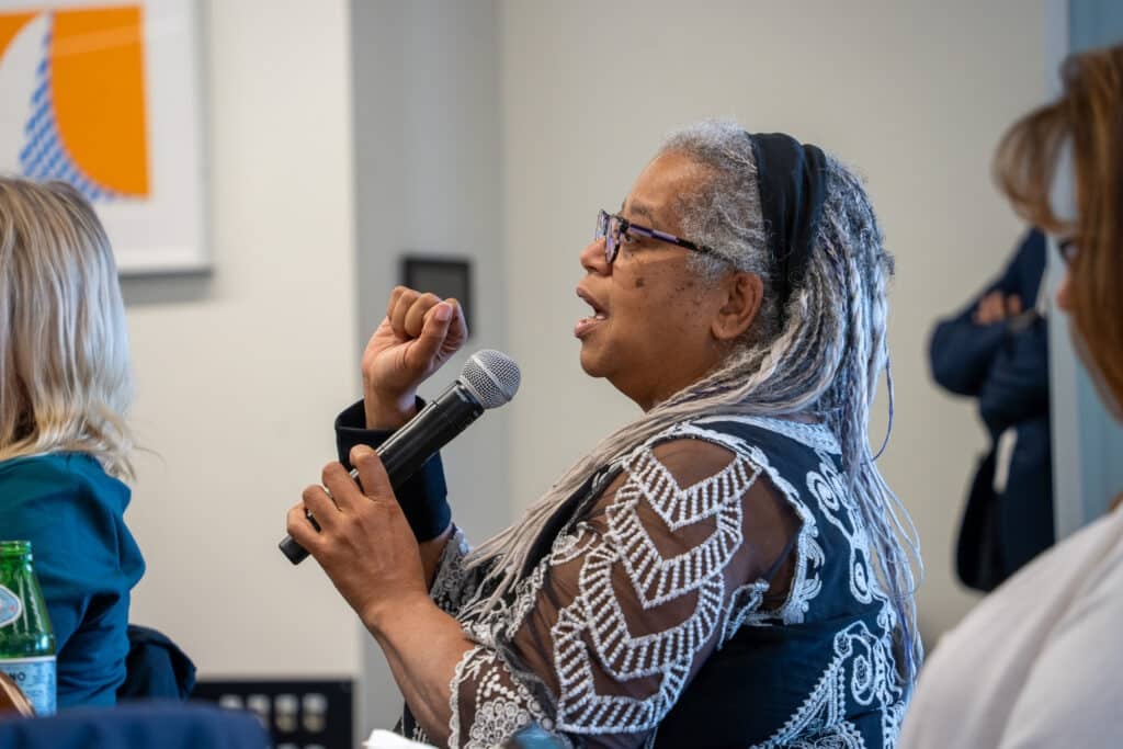 Connie Stewart speaking into a microphone