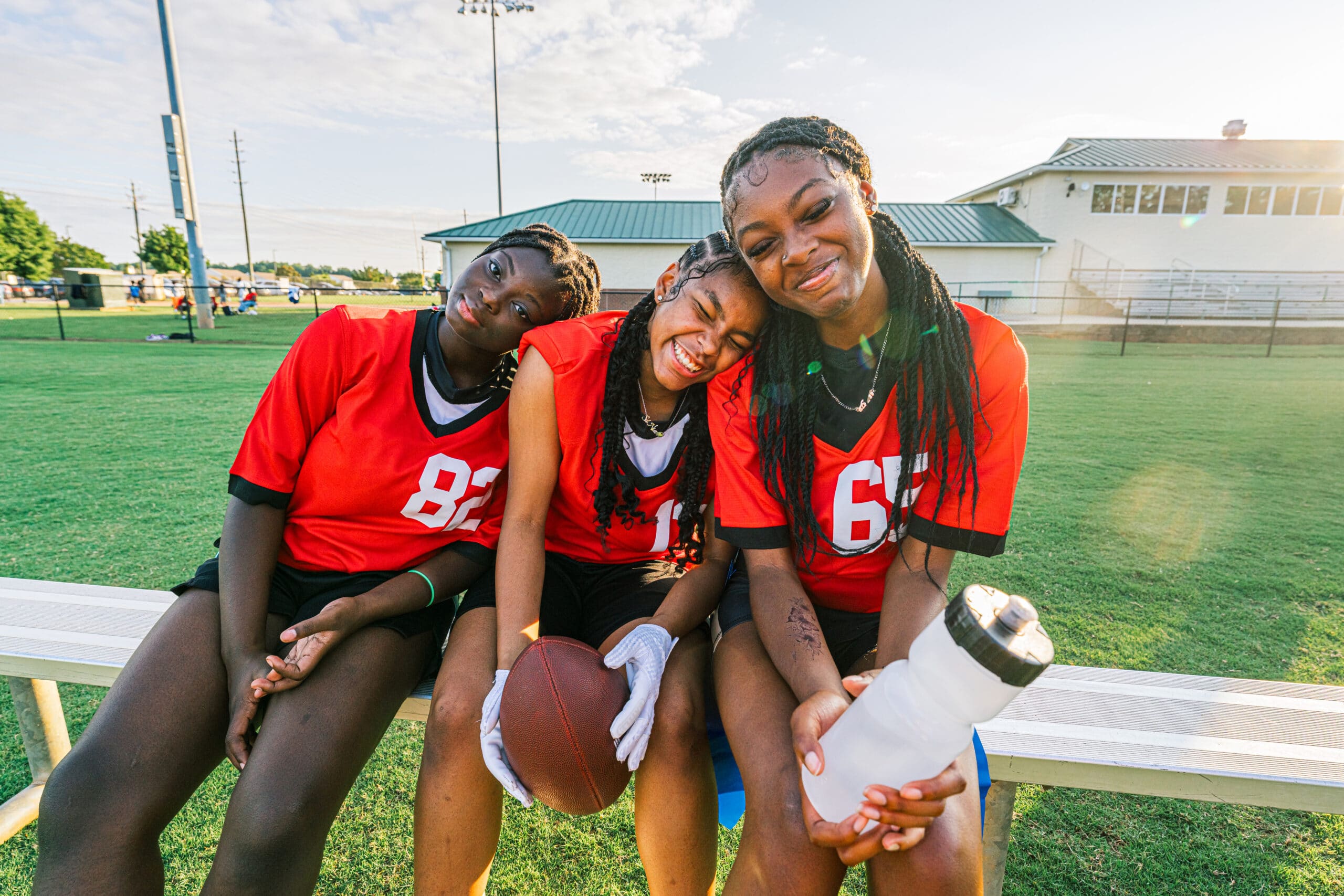 Youth Flag Football Sports Team Bonding and Practicing Together at Sunset in Summer