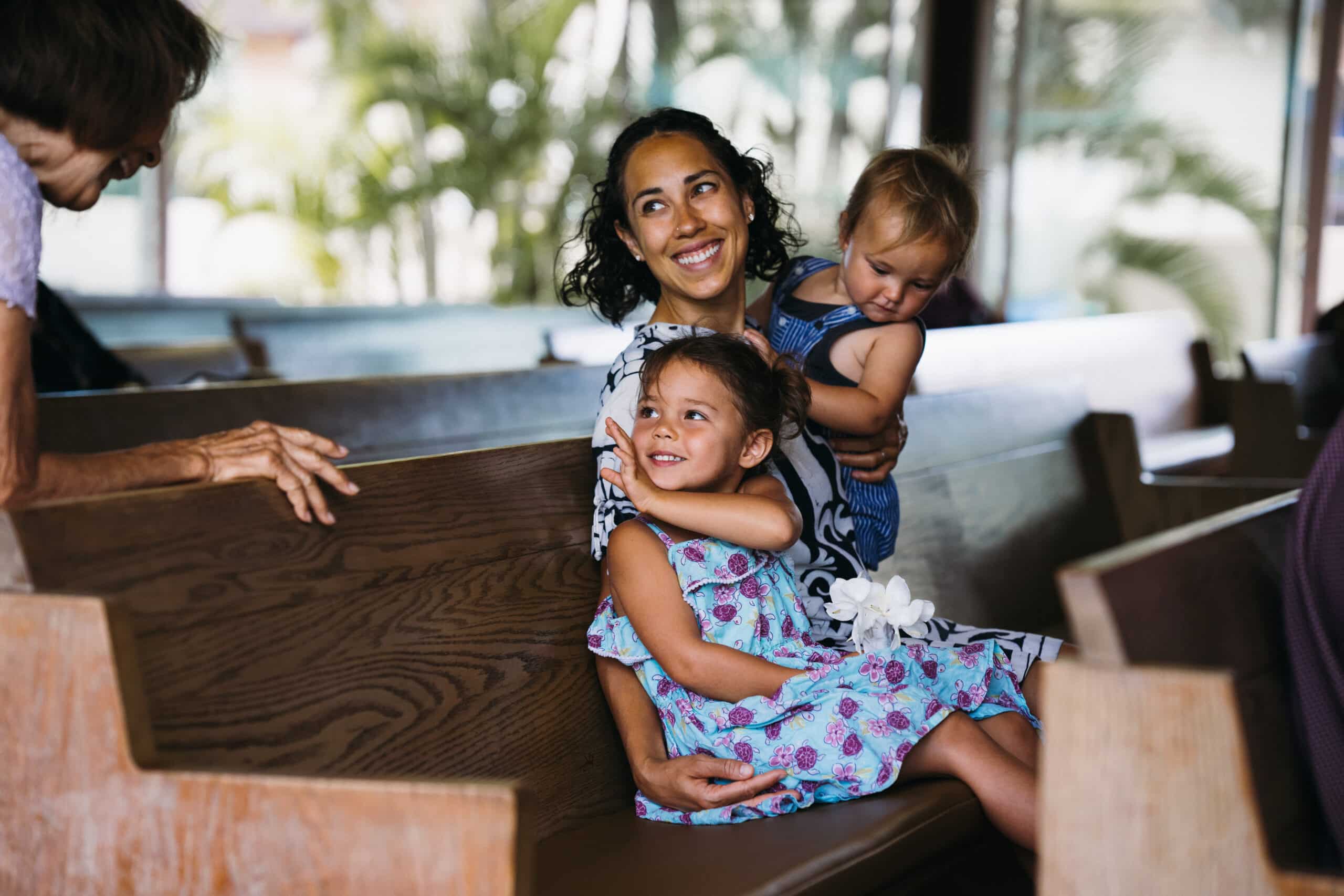 Family in a community gathering space, representing how local institutions sustain identity and trust